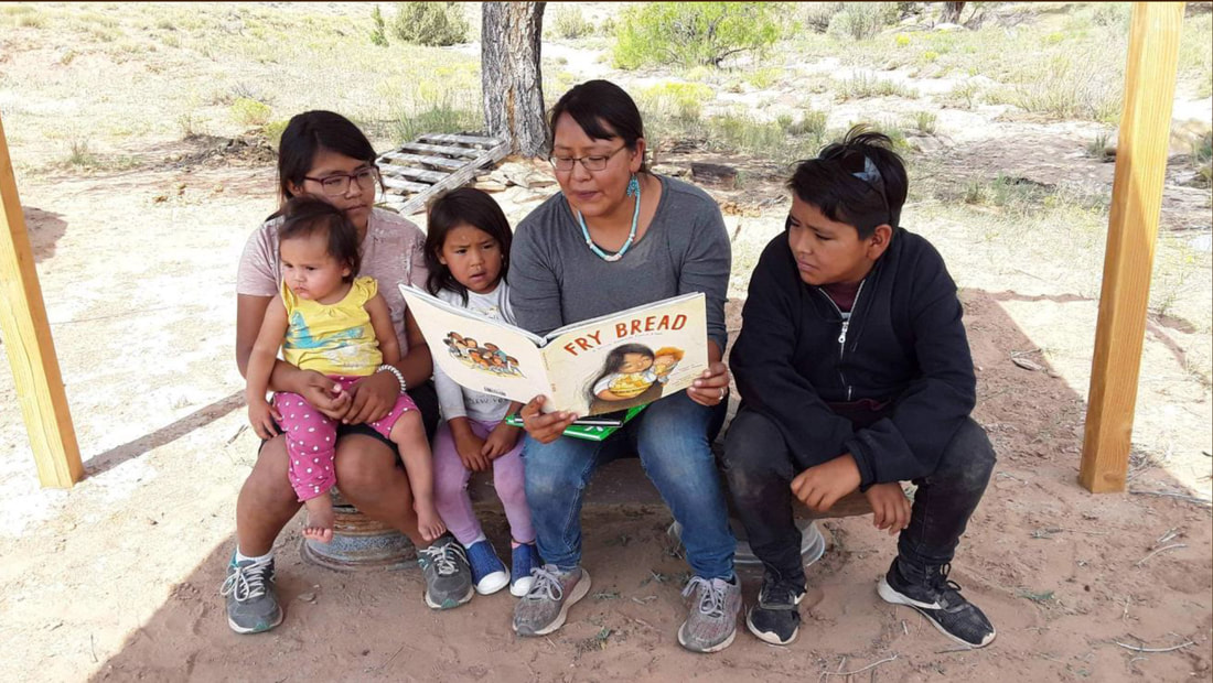 Child reading frybread book