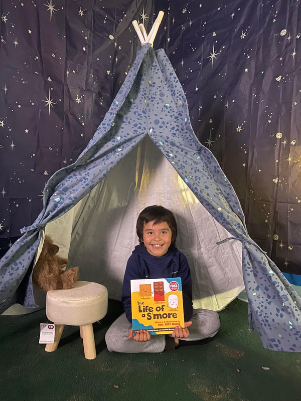 Boy with book at teepee